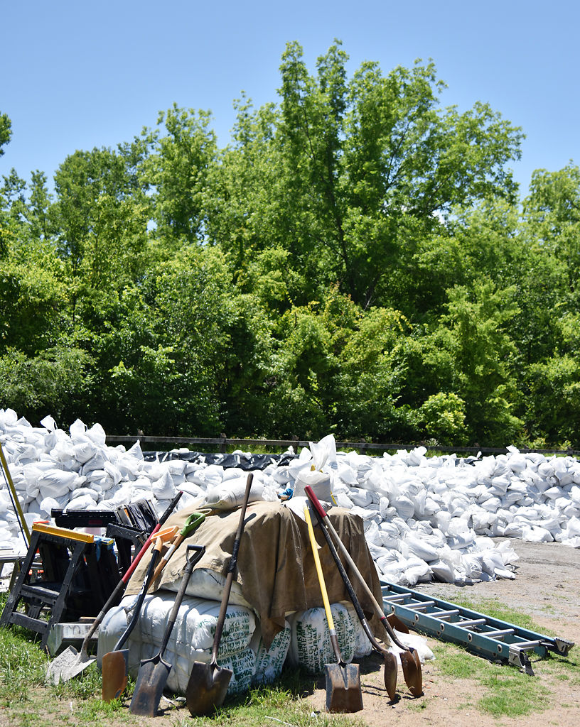 Leftover sandbags made during the rush to build levees sit near the trail head